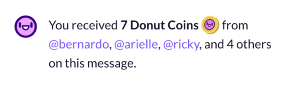 A message that reads "You received 7 Donut Coins from @bernardo, @arielle, @ricky, and 4 others on this message." A custom Donut Shoutouts emoji is displayed next to the words "Donut Coins" in the message. 